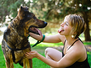 A woman playing with her dog by impersonating it